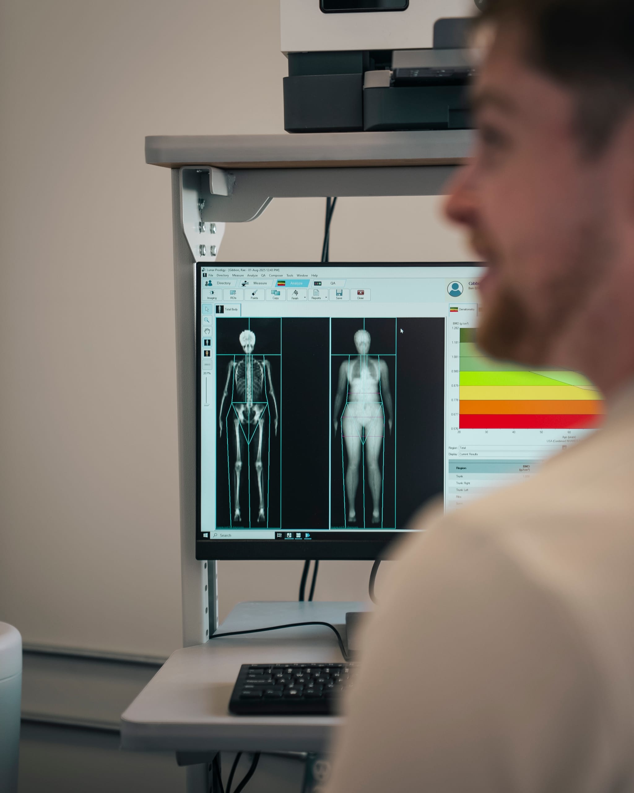 Clinician reviewing a DEXA body composition scan on a monitor